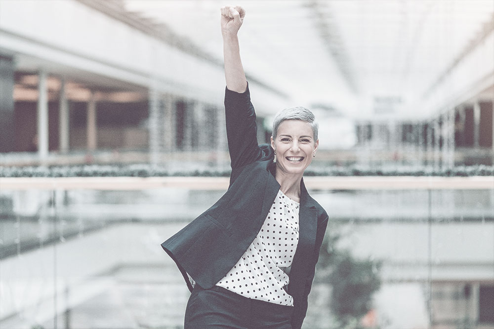 Woman with fist in the air | TIB Financial Services